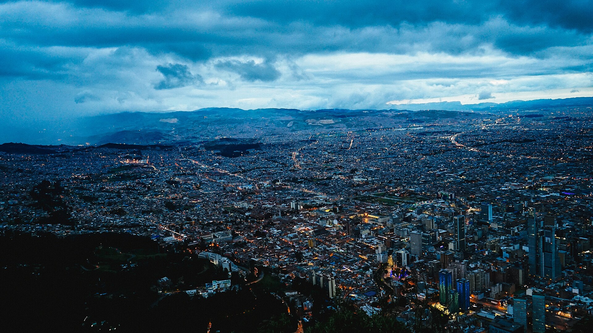 Bogotá at dusk seen from Montserrate, the city lights spreading to the hills